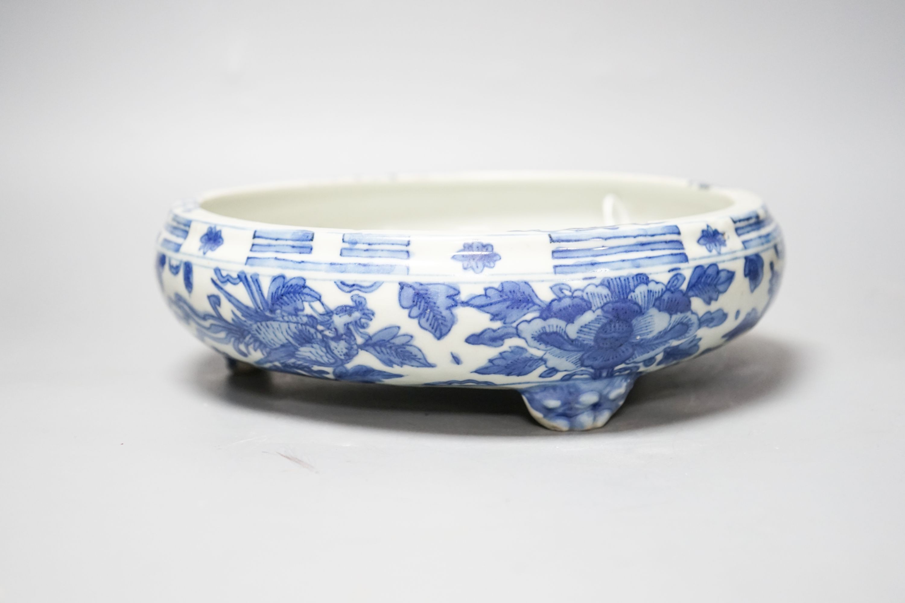 A 19th century Chinese circular blue and white censer, with phoenix and peony decoration, on three lion's paw feet 26cm
